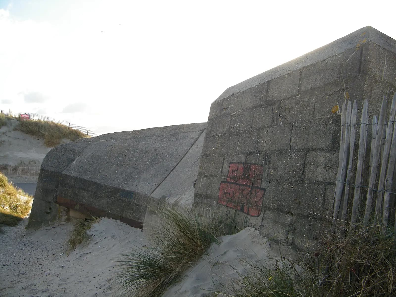 An Atlantic Wall blockhaus at Quend-Plage, tilted in the sand. Not a plate from the book: the subject Virilio spent fifteen years photographing.