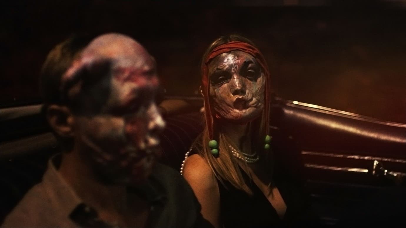 Two people wearing grotesque, distorted masks sit in the back of a car at night.